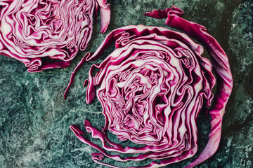 Obraz premium sliced red cabbage steak on green background