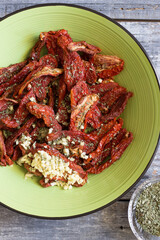 dried tomatoes dressed with garlic, oregano and oil.