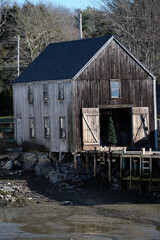 Fototapeta na wymiar Storage and lobster barn on a New England port town