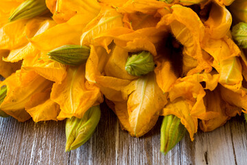 Bouquet of courgette flowers on wooden background