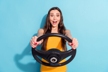 Photo portrait girl keeping steering wheel driving car first time amazed shocked isolated pastel blue color background