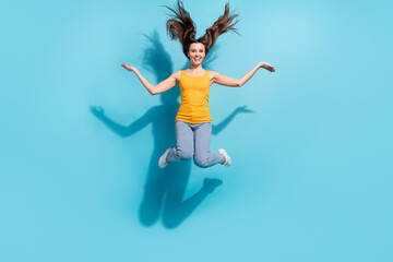 Fototapeta na wymiar Full length body size photo girl careless jumping up happy throwing hair isolated pastel blue color background