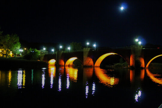 night image of Roman Bridge with orange lights