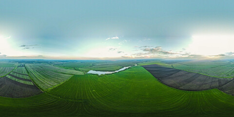 Fototapeta premium the lake in the middle of endless green fields
