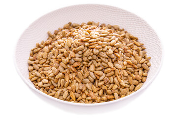 Peeled sunflower seeds in sugar and honey in a white dish on a white background . Isolated items and products.