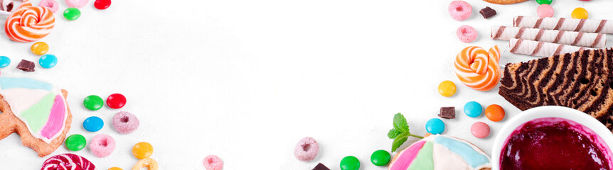 Web banner with sweets assortment on white table. Various confectionery products. Cakes, multicolored sweets, waffles and cookies. Colorful flat lay with copy space