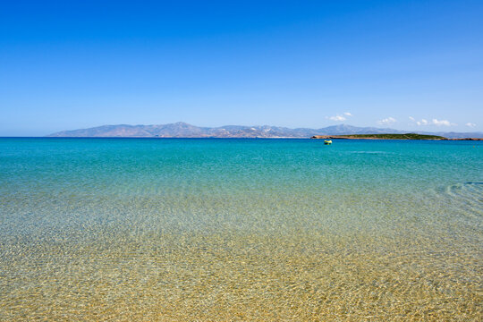 Santa Maria beach with golden sand, emerald waters and view on the island of Naxos. The best beach of Paros. Cyclades, Greece