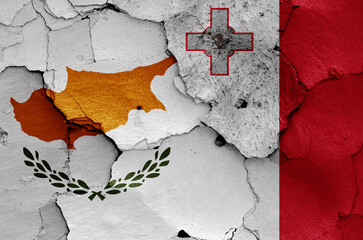 flags of Cyprus and Malta painted on cracked wall