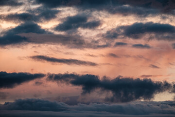 Sunset over a an overcast mountain range and ocean