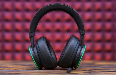 Fototapeta na wymiar Professional Modern headphones with a microphone for gamers on a pink background