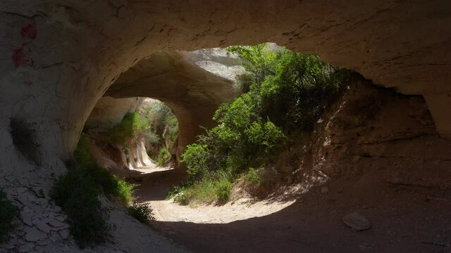 4K stock video footage of tunnel in sandstone volcanic mountain. Landscape of Cappadocia, Turkey