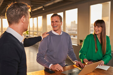 Businessman appreciating male colleague in meeting at office