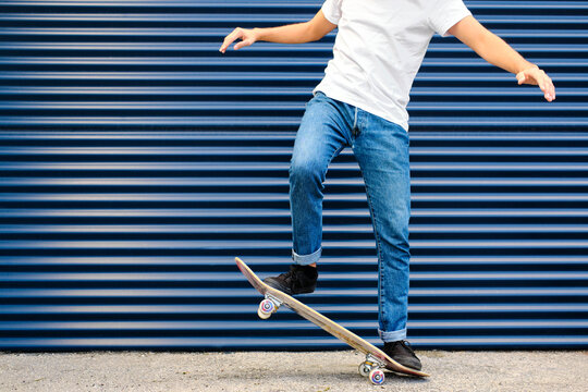 Young man practicing stunt on skateboard