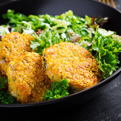Homemade fish croquettes from white fish in cornflakes breading. Fritters from minced cod....