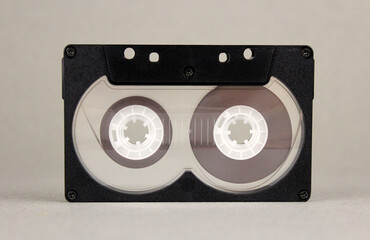 Old audio cassette on gray background
