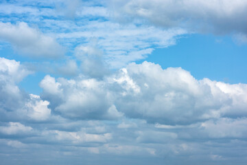 Naklejka na ściany i meble Fluffy white clouds on background of blue sky.