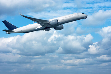 Fototapeta na wymiar A big jet taking off in blue cloudy sky.