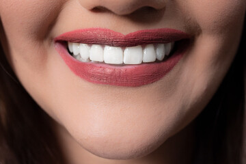 Woman with red lipstick and toothy smile