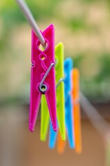 Colored clothespins hanging by a thread