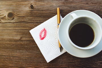 Napkin with a kiss on a wooden table in a cafe top view