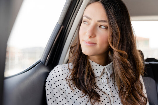 Beautiful businesswoman looking away while sitting in car