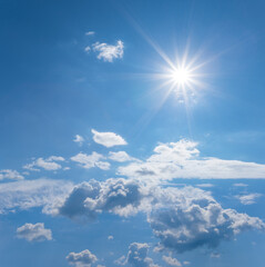 blue cloudy sky with sparkle sun, natural summer background