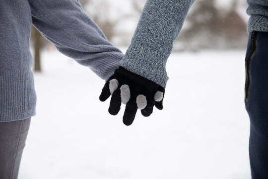 Couple With Gloves Holding Hands During Winter