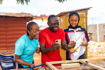 African carpenter feeling excited about what he saw on his client phone