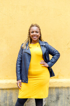Confident plus size woman standing with hand on hip