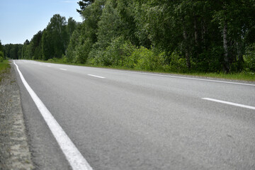 High-speed asphalt highway in the forest during the day