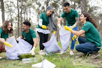 Smiling male and female volunteers collecting plastic in forest