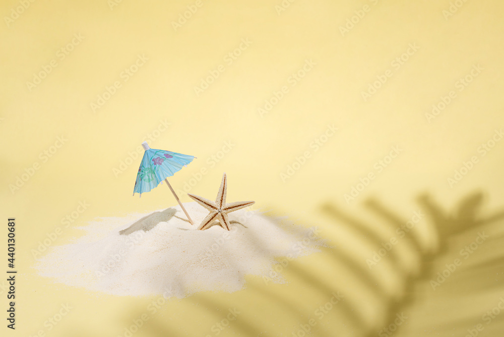 Wall mural palm leaf shadow on yellow background with sand island and umbrella, sea vacation concept.