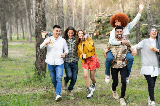 Carefree male and female friends having fun at forest
