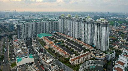 Aerial view of new green urban landscape in the city. Cityscape of a residential area with modern apartment buildings when sunset. Jakarta, Indonesia, Juni 18, 2021