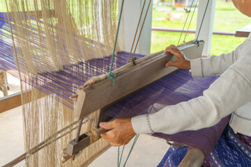 Local people hands using traditional manual weaving wool handloom textile cloth fabric machine yarn...