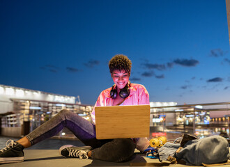 Woman using laptop during night