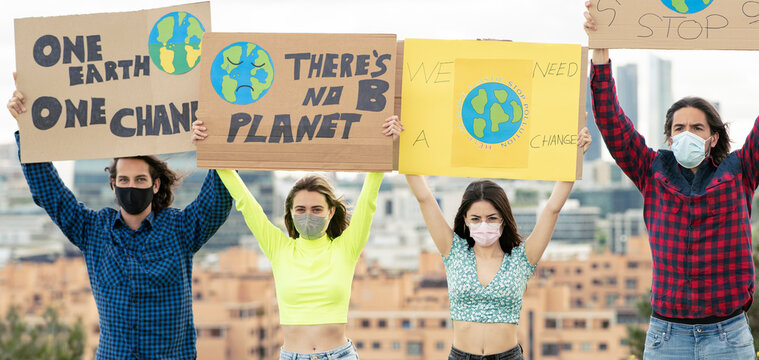 Activist standing with alertness poster on climate change