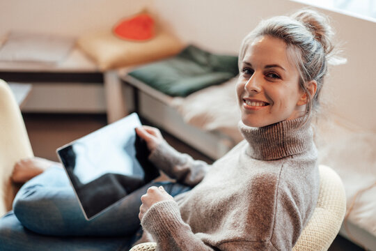 Smiling woman with digital tablet at cafe