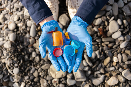 Woman in protective glove holding plastic cap