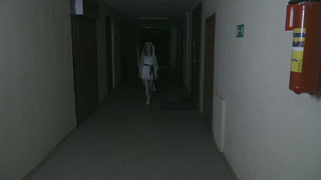 the ghost of the bride walks down the dark corridor