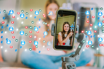 Female influencer showing hashtag while vlogging through smart phone at home