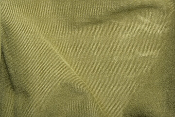 Deep moss green denim fabric with texture and worn feel for design, backgrounds and textures, displacement maps and copy space