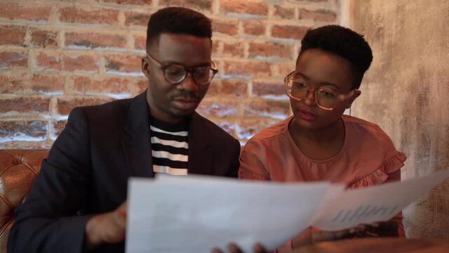 Two young African American colleagues working.