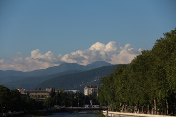 clouds, mountains, blue sky and buildings