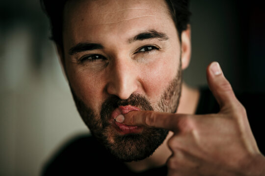 Man licking index finger