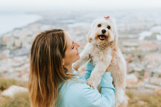 Mid adult woman looking while holding pet