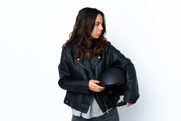 Young woman holding a motorcycle helmet over isolated white background portrait