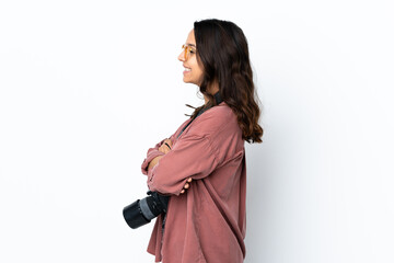 Young photographer woman over isolated white background in lateral position