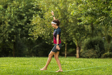 Female sportsperson slacklining at park
