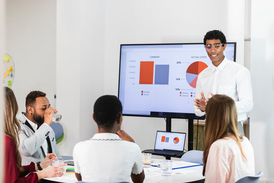 Male and female colleagues working on business plan in meeting